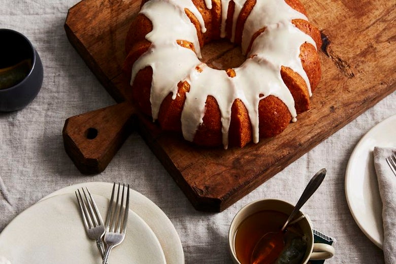 An orange bundt cake with white glaze